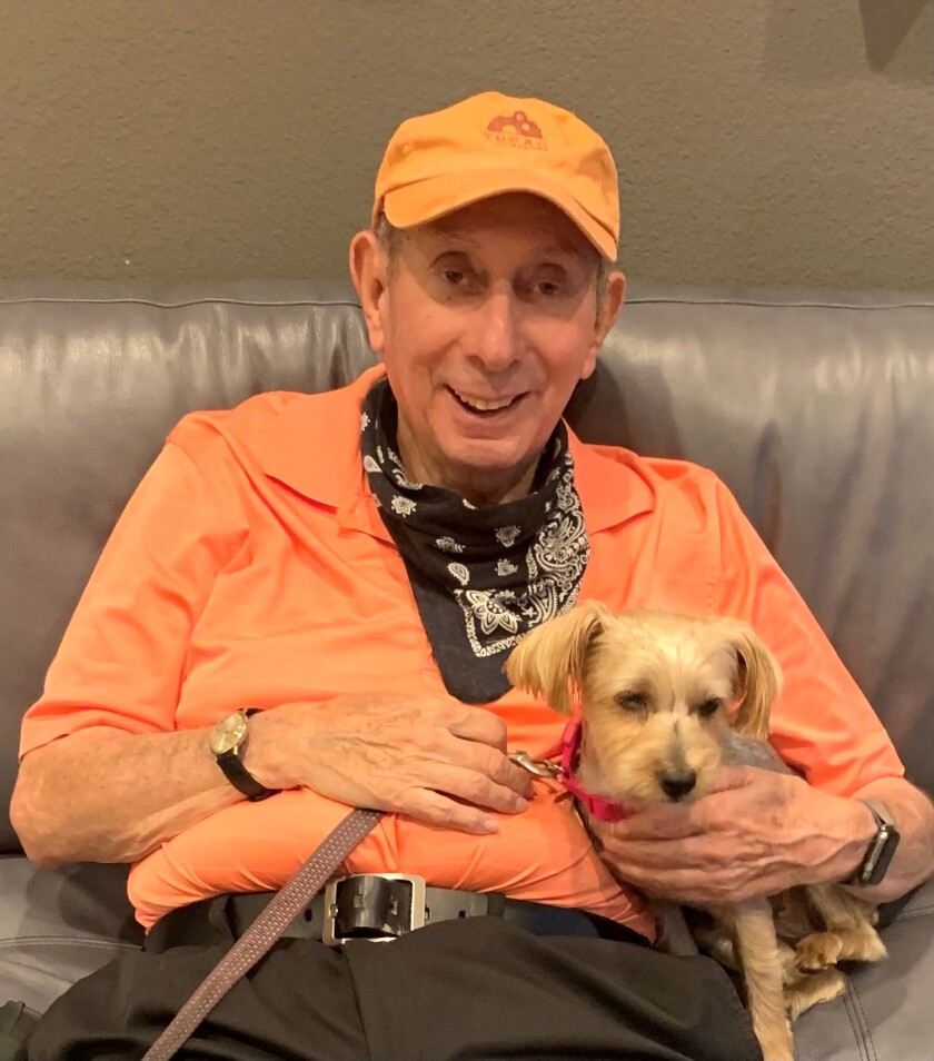 La Jolla resident Tom Hassey (pictured with his dog, Coco) retired from teaching this month at age 83.
