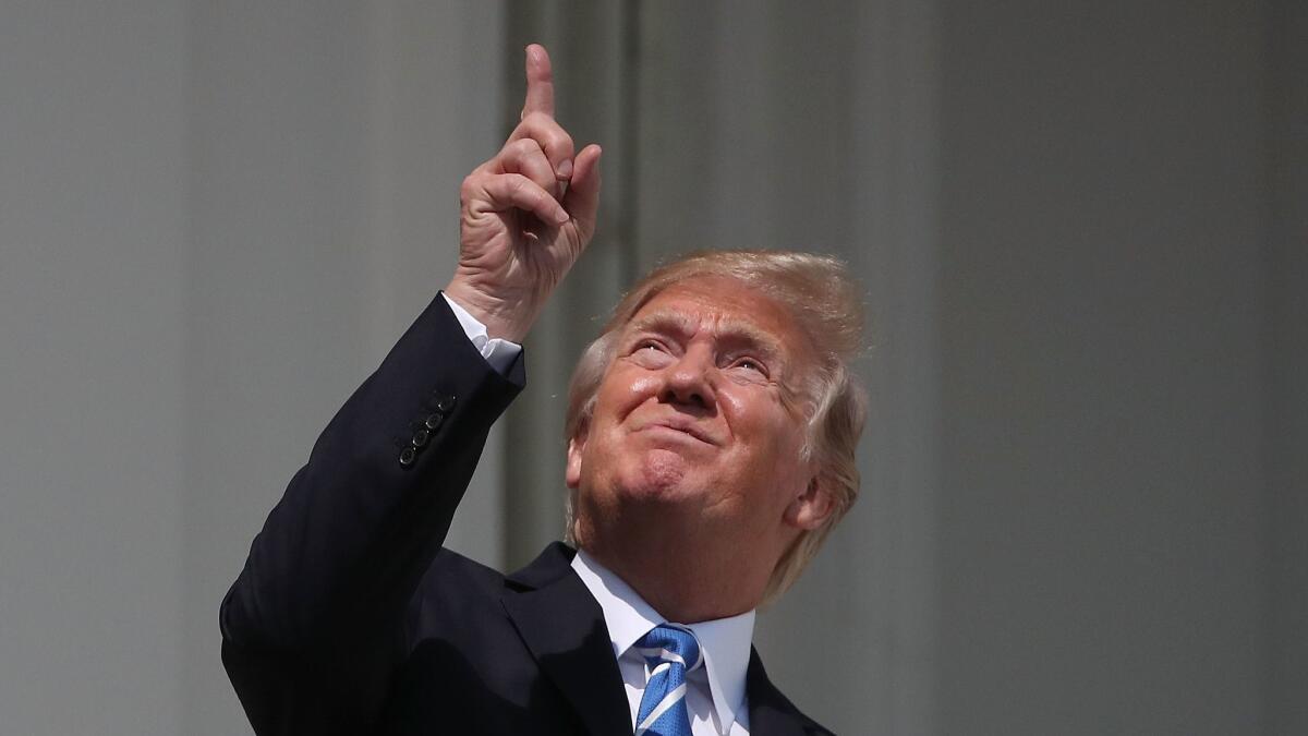 President Trump looks up toward a solar eclipse from the White House on Aug. 21, 2017.
