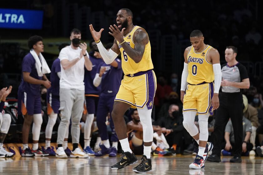 Los Angeles Lakers' LeBron James reacts to a foul called on him during first half of the team's game against the Phoenix Suns