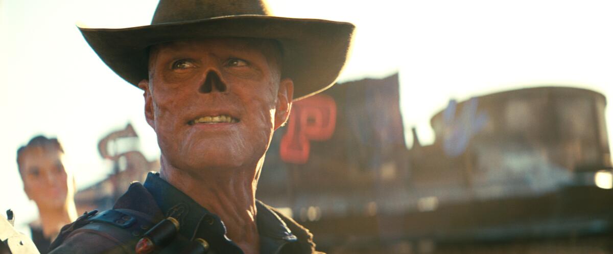 A man with a scarred face and no nose wears a cowboy hat in "Fallout."