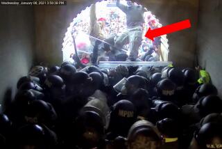 This image from video from the Justice Department contained in the sentencing memorandum, and annotated by the source, shows David Nicholas Dempsey stomping on police officers in the Lower West Terrace Tunnel at the U.S. Capitol on Jan. 6, 2021, in Washington. Dempsey, a California man with a history of political violence, was sentenced on Aug. 9, 2024, to 20 years in prison for repeatedly attacking police with flagpoles and other makeshift weapons during the riot at the U.S. Capitol. (Justice Department via AP)