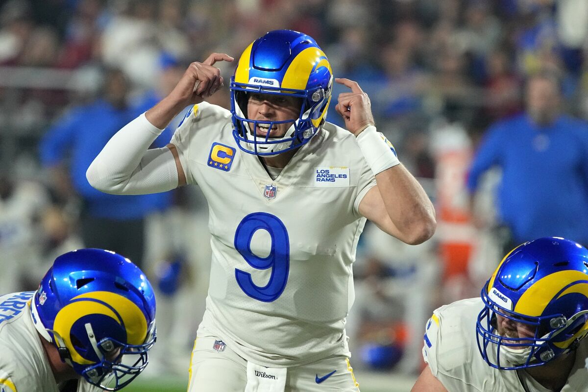 Matthew Stafford signals to fellow Rams at the line of scrimmage in an NFC West game against the Cardinals.