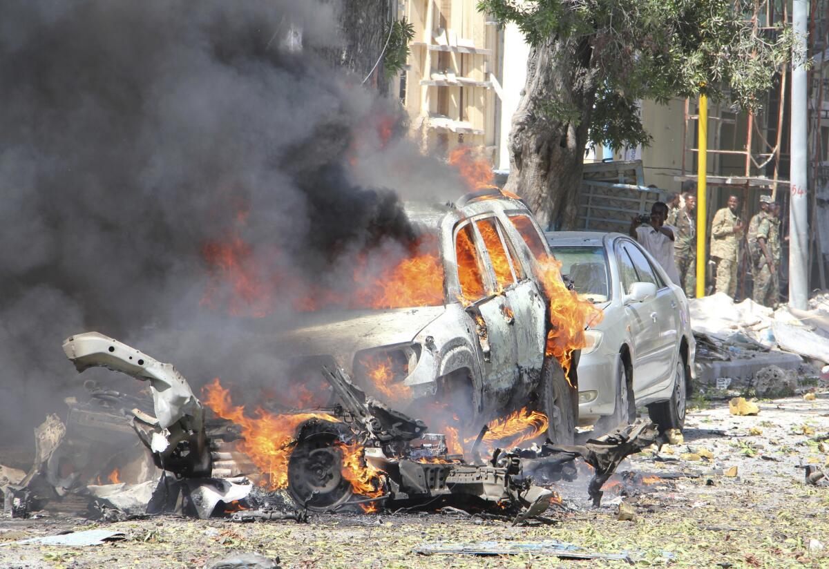 A car burns along the street after an explosion in Mogadishu, Somalia, on Saturday, Oct. 1, 2016.