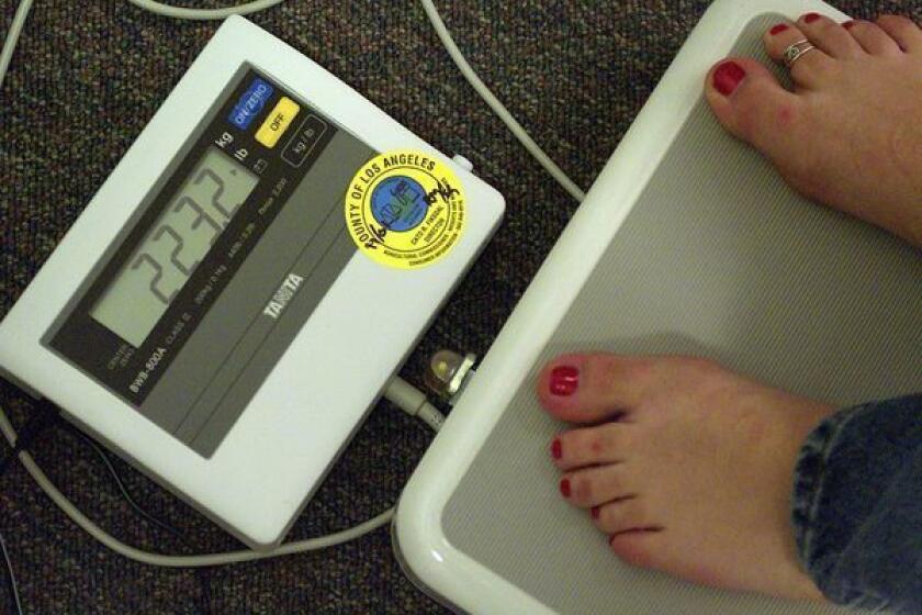 Weigh-in at a Weight Watchers meeting in Pasadena. 2013 brings new resolutions to shed pounds.