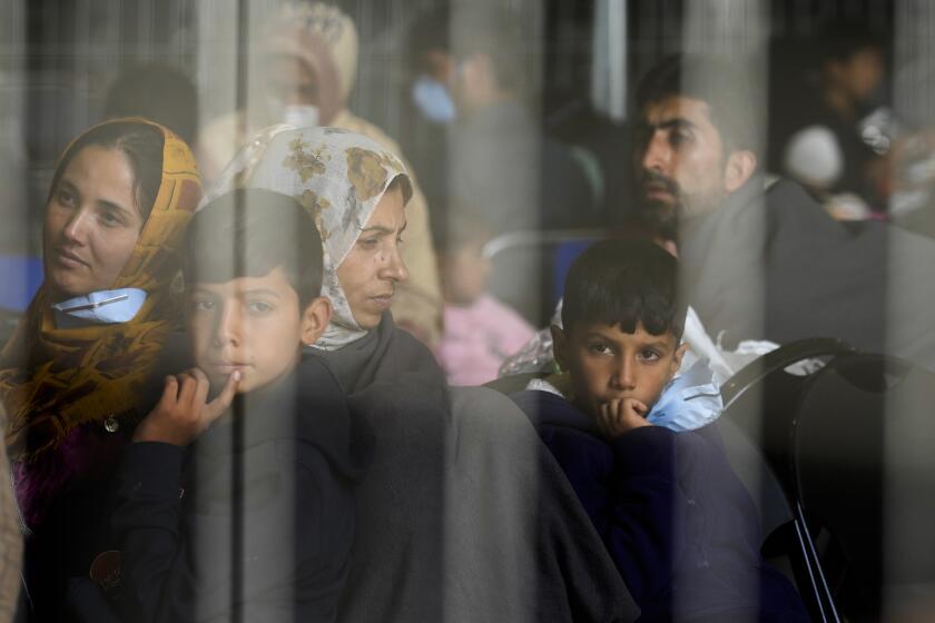 FILE - Evacuees from Afghanistan wait with other evacuees to fly to the United States or another safe location in a makeshift departure gate inside a hanger at the United States Air Base in Ramstein, Germany, Sept. 1, 2021. The Afghan man who speaks only Farsi represented himself in U.S. immigration court, and the judge denied him asylum. The Associated Press obtained a transcript of the hearing that offers a rare look inside an opaque and overwhelmed immigration court system where hearings are closed and judges are under pressure to move quickly given the backlog of 2 million cases. (AP Photo/Markus Schreiber, File)