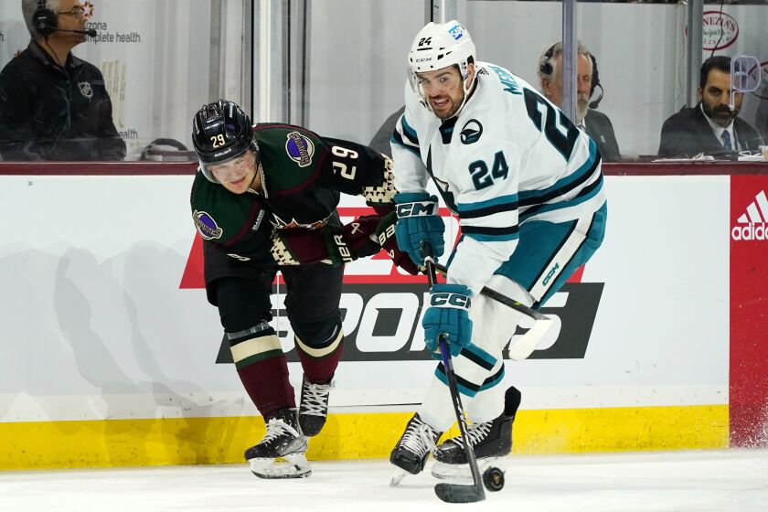 FILE - San Jose Sharks defenseman Jaycob Megna (24) skates with the puck against Arizona Coyotes center Barrett Hayton (29) during the first period of an NHL hockey game in Tempe, Ariz., Jan. 10, 2023. The Seattle Kraken acquired Megna from the Sharks on Sunday, Feb. 5, 2023, in exchange for a 2023 fourth-round draft pick. (AP Photo/Ross D. Franklin, File)