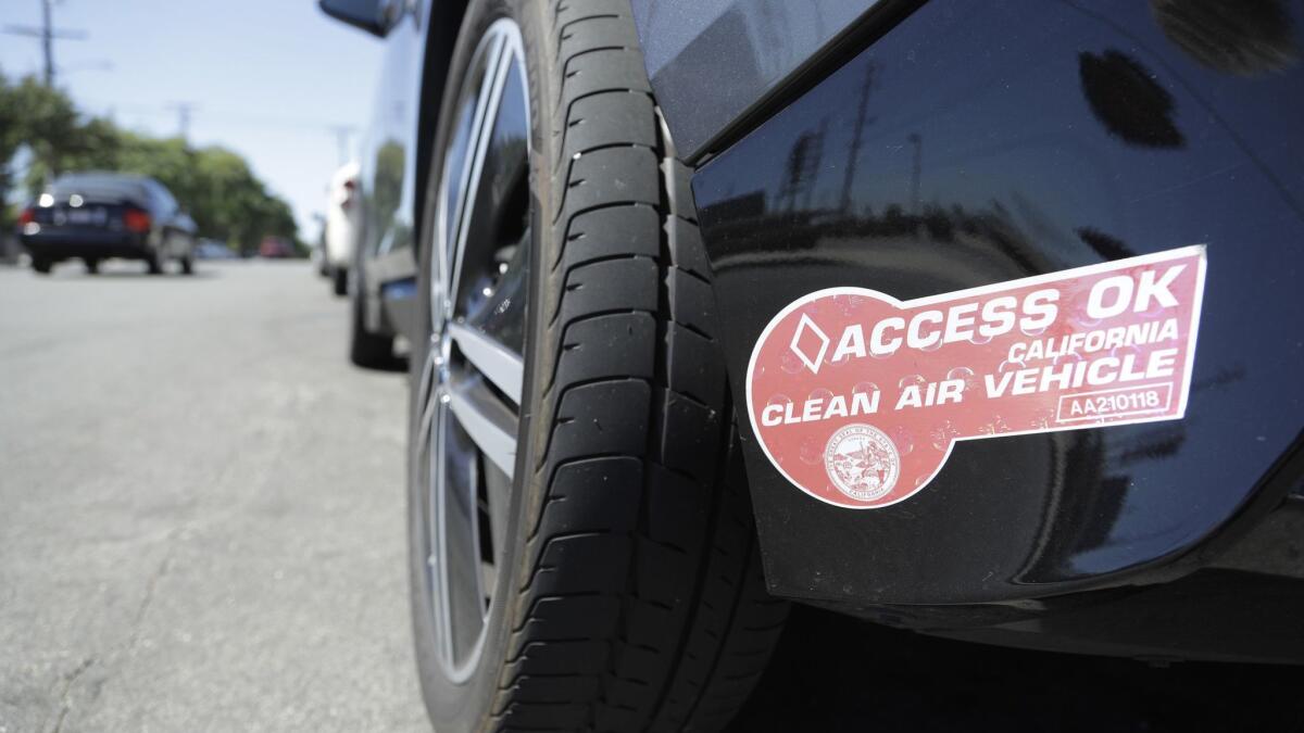 The red clean-air decal is for vehicles that meet California's strict emissions standards. Drivers issued white or green decals in 2017 or 2018 can apply for a red sticker, but those who bought before 2017 would have to buy a new car to keep driving solo in carpool lanes.