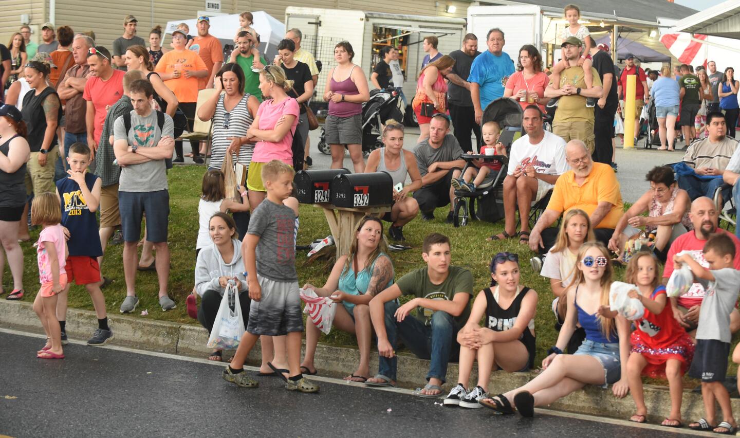 People line York Street to watch the parade leading to the Manchester Volunteer Fire Company carnvial on Tuesday, July 2.