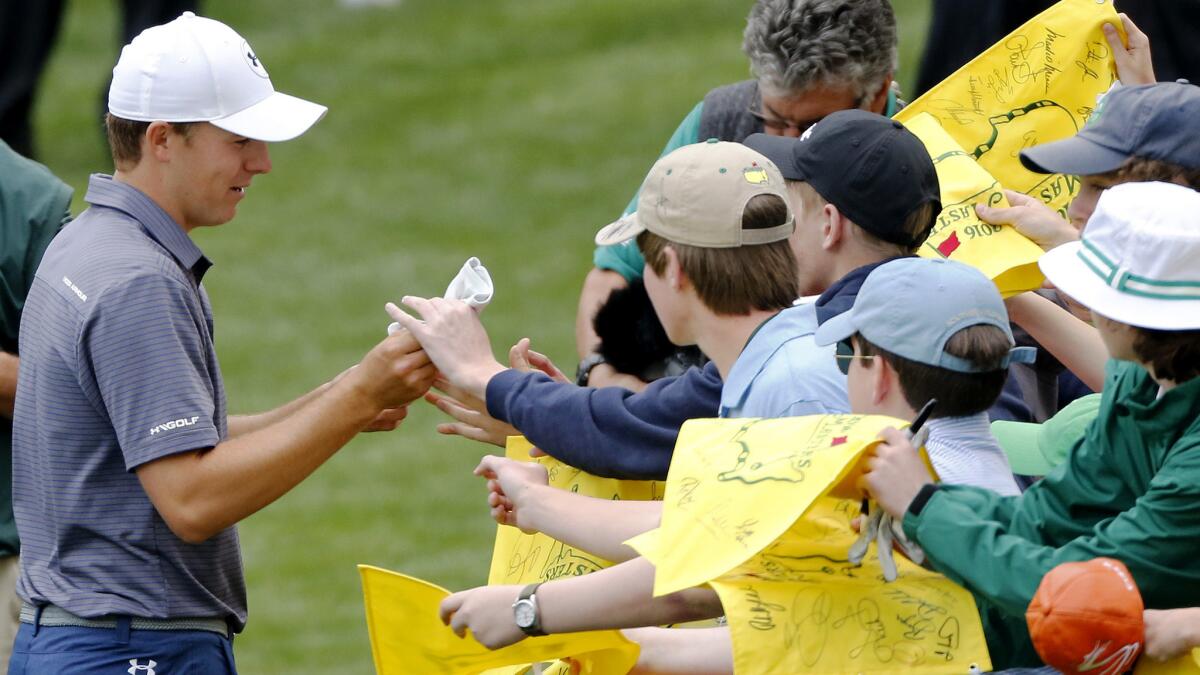 Jordan Spieth signs autographs on the ninth hole during the par-three contest on Wednesday at Augusta National Golf Club.