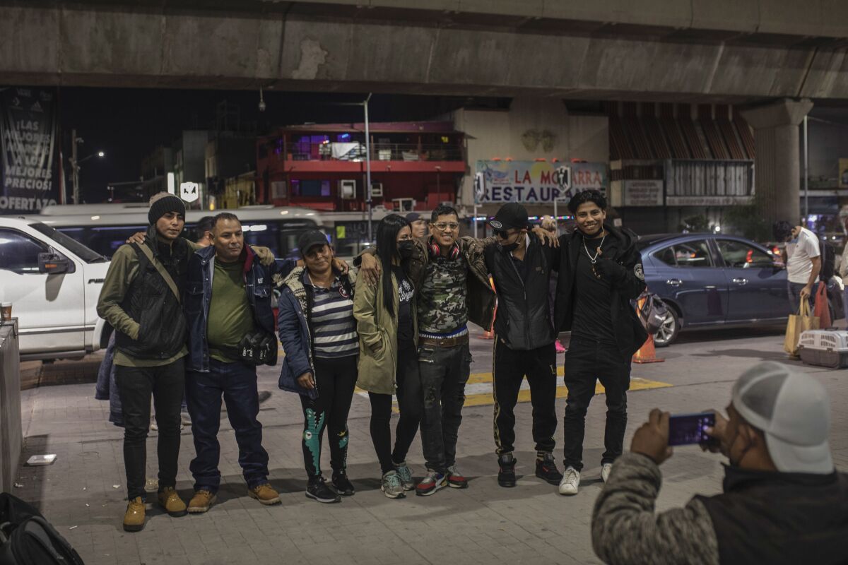 A group of migrants poses for a photo