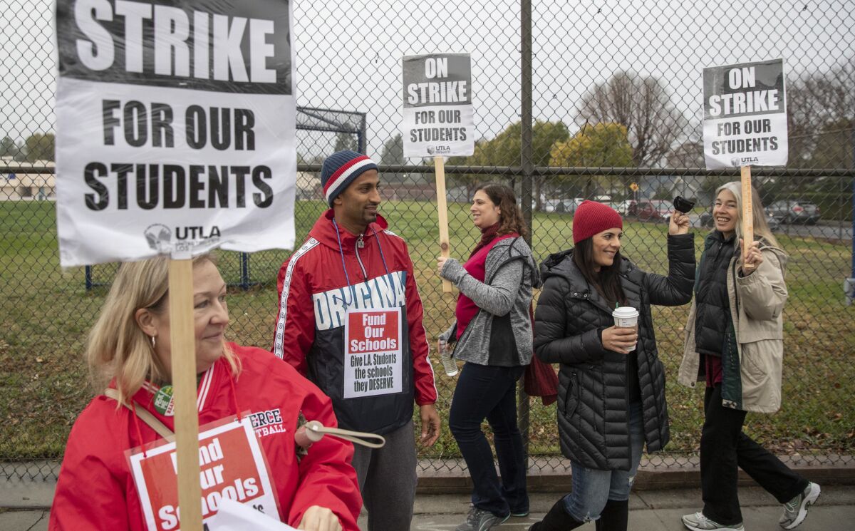 Hale Charter Academy teachers Chetan Singh, second from left, and wife Daksha Singh, second right, on the picket line at their middle school campus in Woodland Hills.