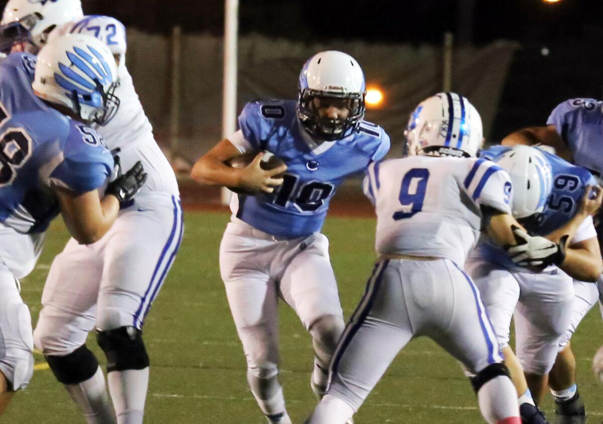 Crescenta Valley quarterback Chase Center runs up the middle against Burbank during Friday's Pacific League game.