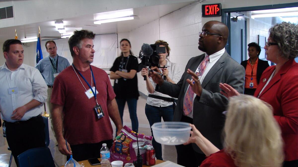 Solomon Graves, right, tells journalists the rules for selecting media witnesses for the execution of Kenneth Williams at the Cummins Unit prison in Varner, Ark.