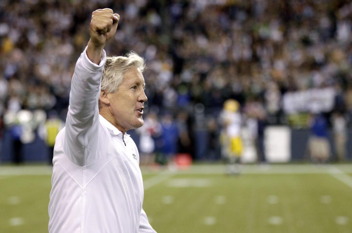 Seattle Seahawks Coach Pete Carroll celebrates after the officials' ruling at the end of the Seahawks-Packers game.