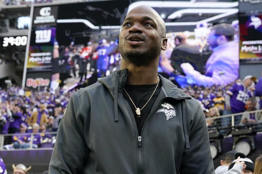 Former Minnesota Vikings running back Adrian Peterson stands on the field before an NFL wild card playoff football game