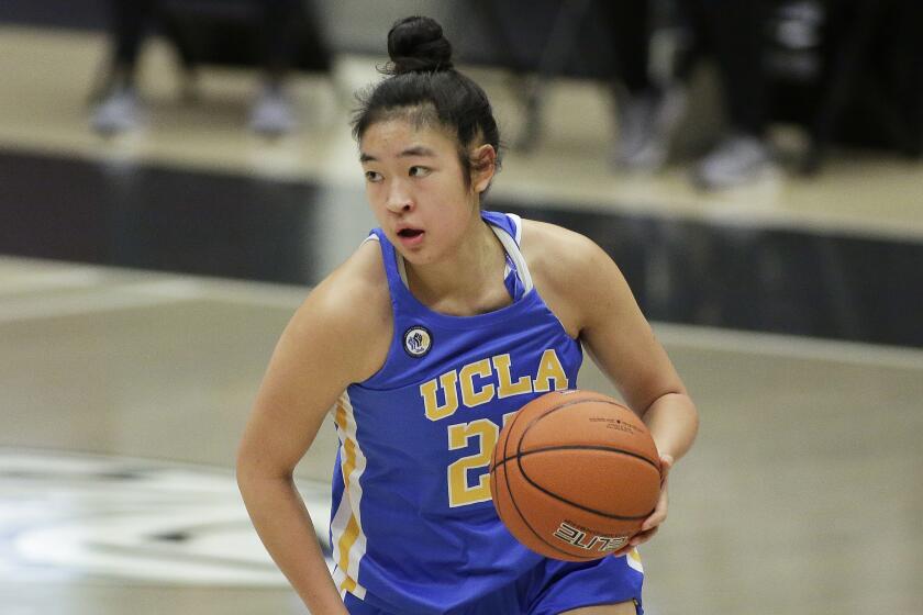 UCLA guard Natalie Chou brings the ball up the court during the second half of an NCAA college basketball game.