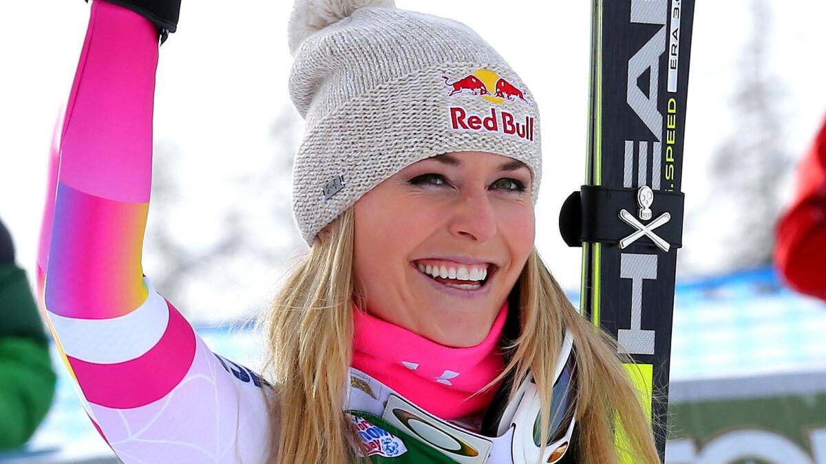 Lindsey Vonn celebrates after her record victory in a World Cup super-G race in Italy on Monday.