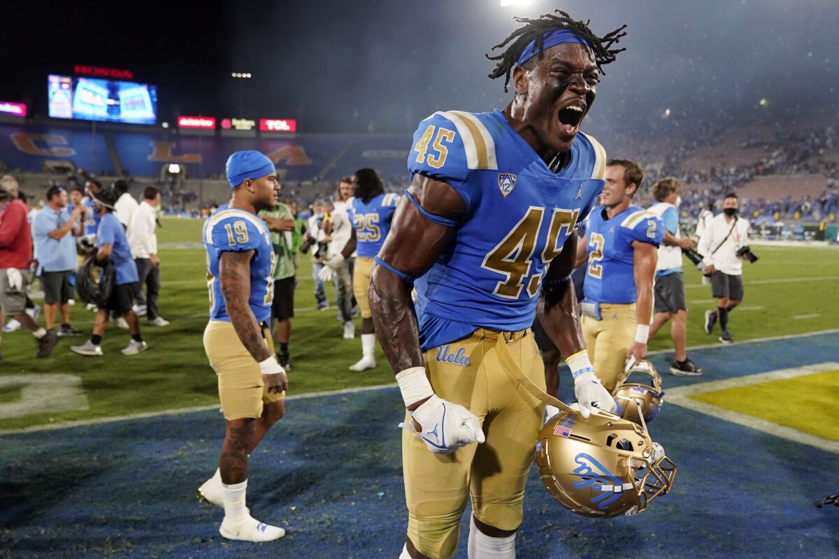 UCLA linebacker Mitchell Agude (45) celebrates the team's win over LSU in an NCAA college football game Saturday, Sept. 4, 2021, in Pasadena, Calif. (AP Photo/Marcio Jose Sanchez)