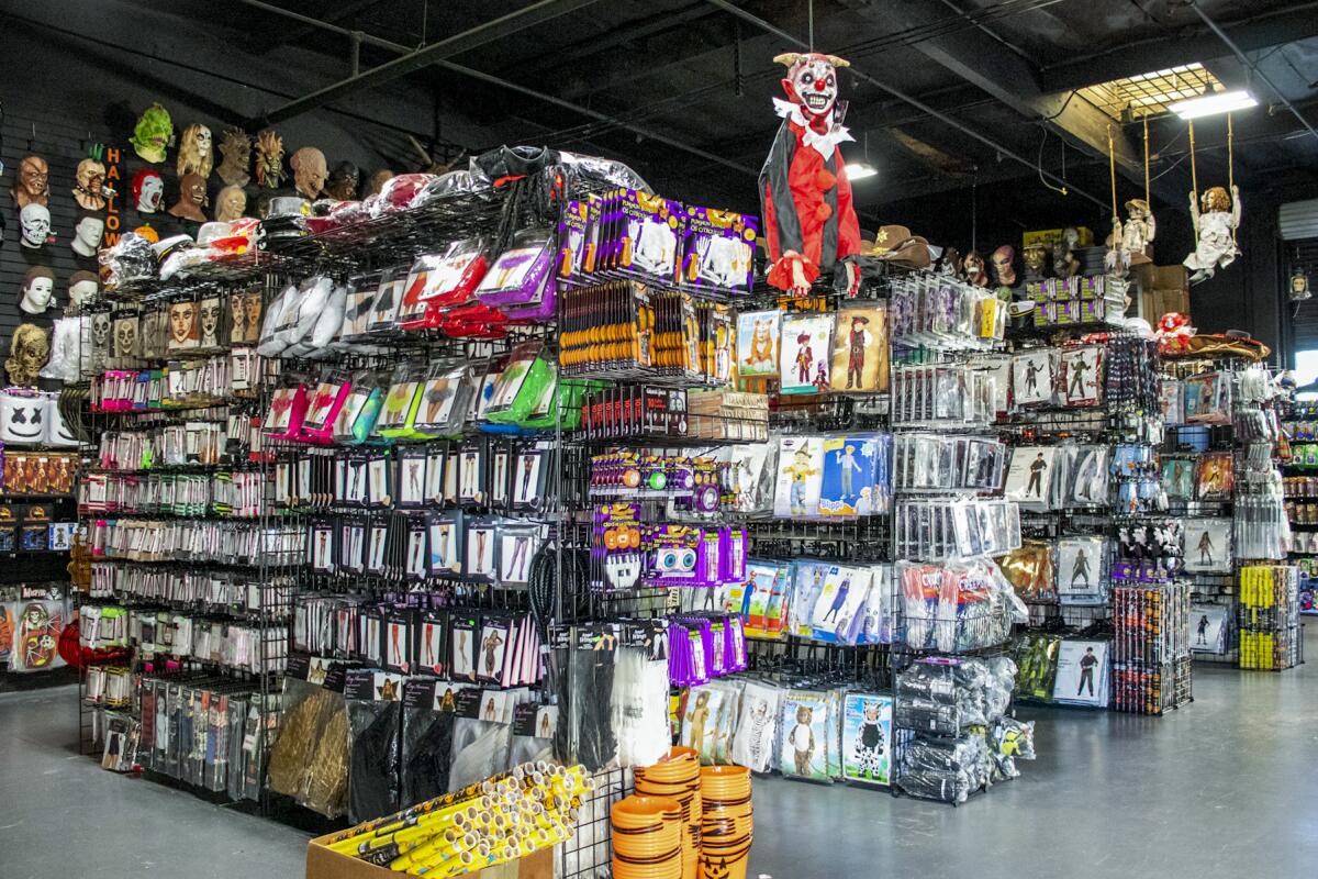 Aisles with packaged costumes and other Halloween supplies 