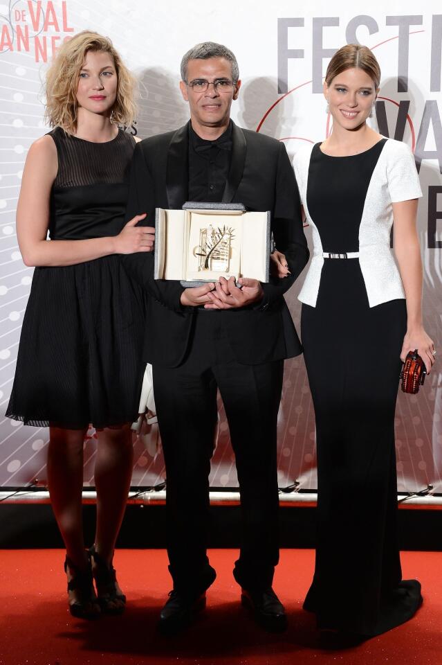 Actress Mona Walravens, left, director Abdellatif Kechiche and actress Lea Seydoux, winner of the Palme d'Or for "La Vie D'adele" ("Blue Is the Warmest Color"), attend the Palme D'Or Winners dinner.