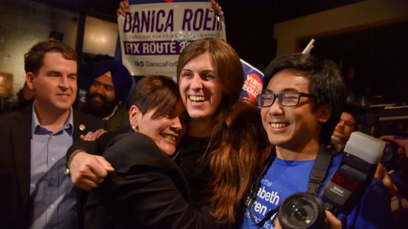 Danica Roem, center, who ran for house of delegates against GOP incumbent Robert Marshall, is greeted by supporters as she prepares to give her victory speech in Manassas, Va on Nov. 7.