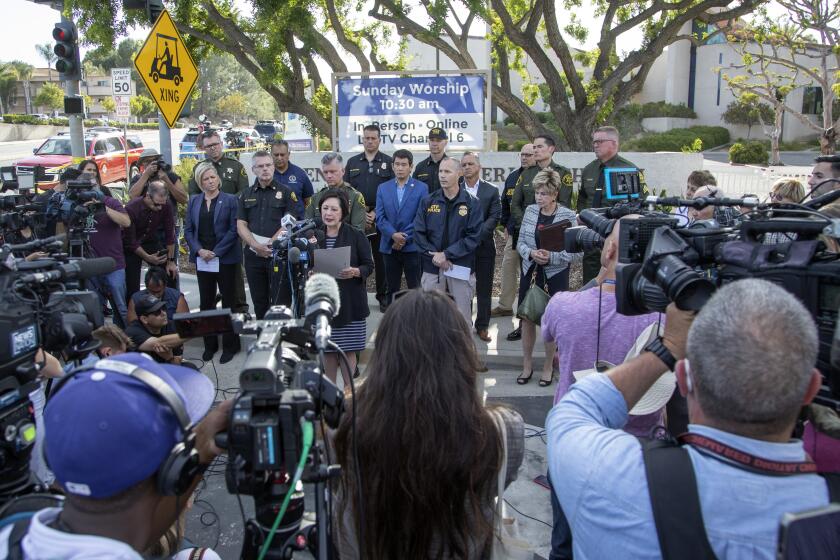 LAGUNA WOODS, CA - MAY 15: Officials hold a press conference in front of Geneva Presbyterian Church in Laguna Woods where a gunman killed one person and injured five others on Sunday, May 15, 2022. (Myung J. Chun / Los Angeles Times)