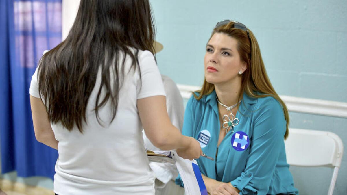 Former Miss Universe Alicia Machado, seated, campaigns for Hillary Clinton last month in Miami.