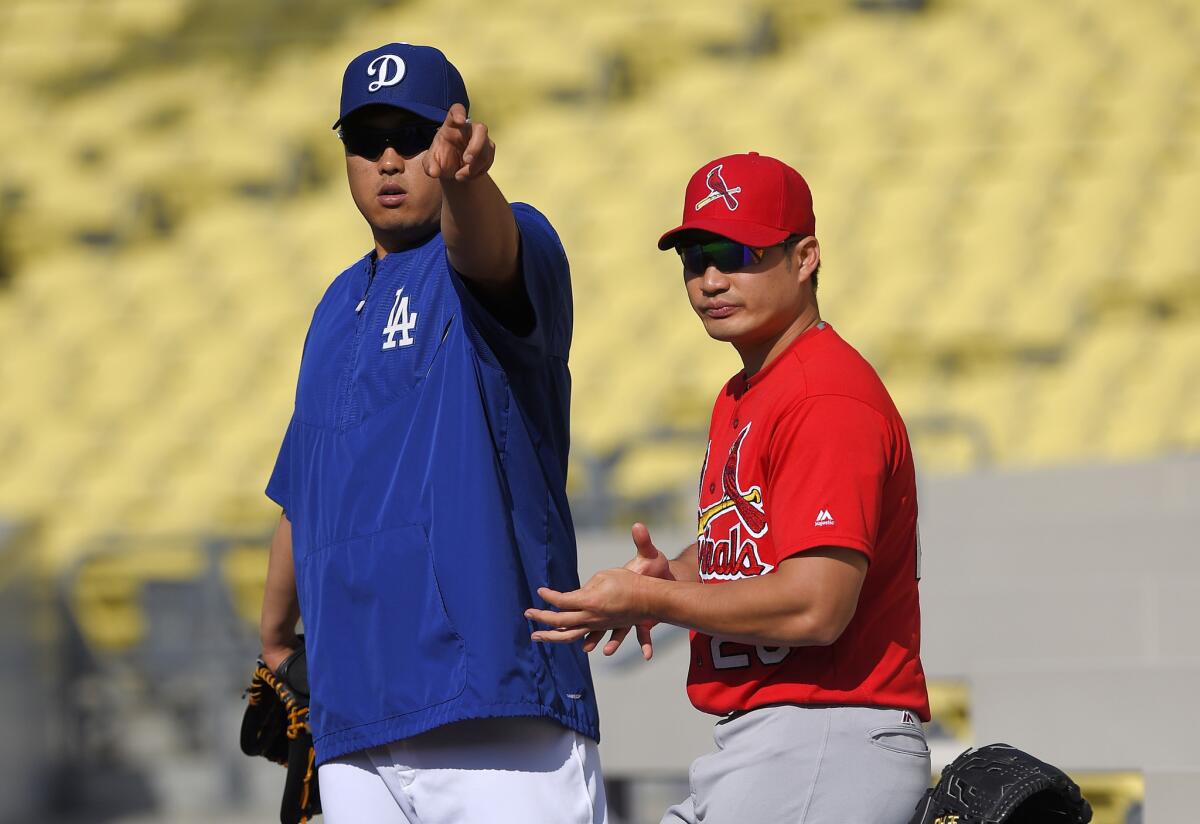 Dodgers pitcher Hyun-Jin Ryu talks with Cardinals reliever Seung Hwan Oh before the start of a game on May 13.