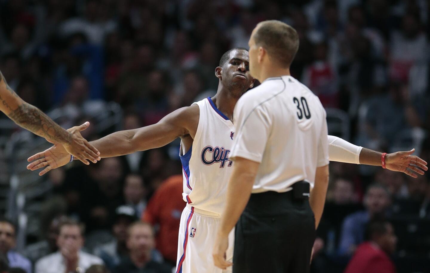 Clippers point guard Chris Paul reaches out for a congratulatory hand slap after hitting a tough shot and drawing a foul against the Thunder in the third quarter.