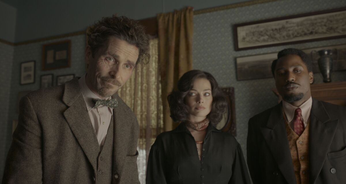 Two men and a woman in a scene from "Amsterdam."