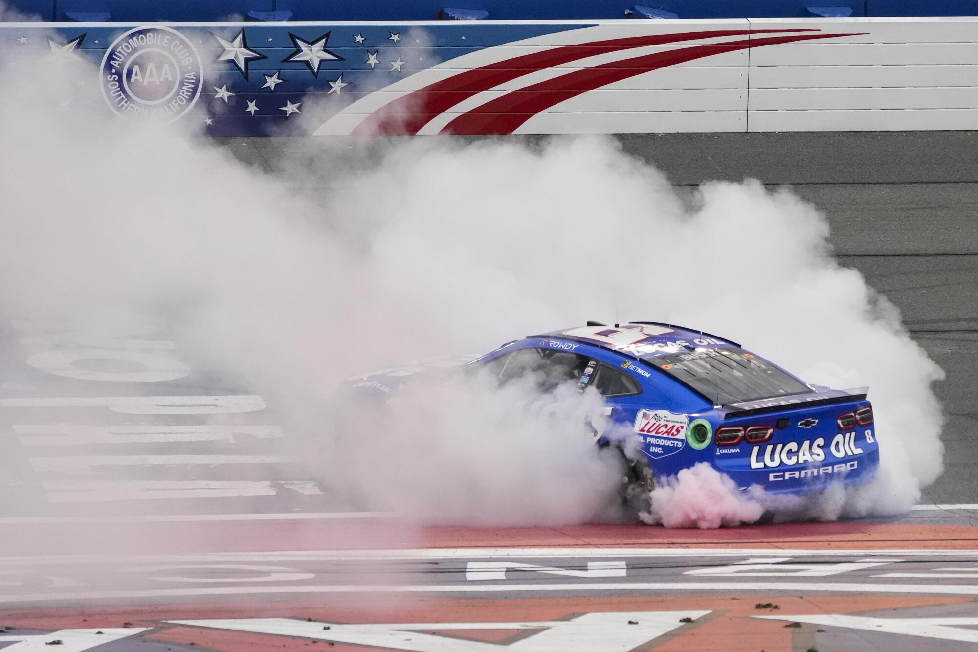 NASCAR driver Kyle Busch burns his tires after winning a 2023 Cup Series race at Auto Club Speedway in Fontana.