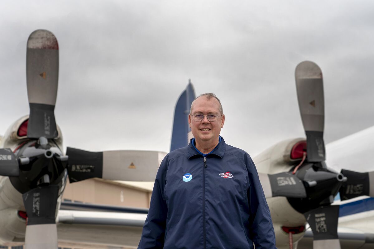 FILE - National Hurricane Center Director Ken Graham poses for a portrait in front of WP-3D Orion "hurricane hunter" aircraft during a hurricane awareness tour at Washington National Airport, Arlington, Va., May 3, 2022. The National Oceanic and Atmospheric Administration on Tuesday, June 7, named Graham the overall boss of the weather service. (AP Photo/Gemunu Amarasinghe, File)