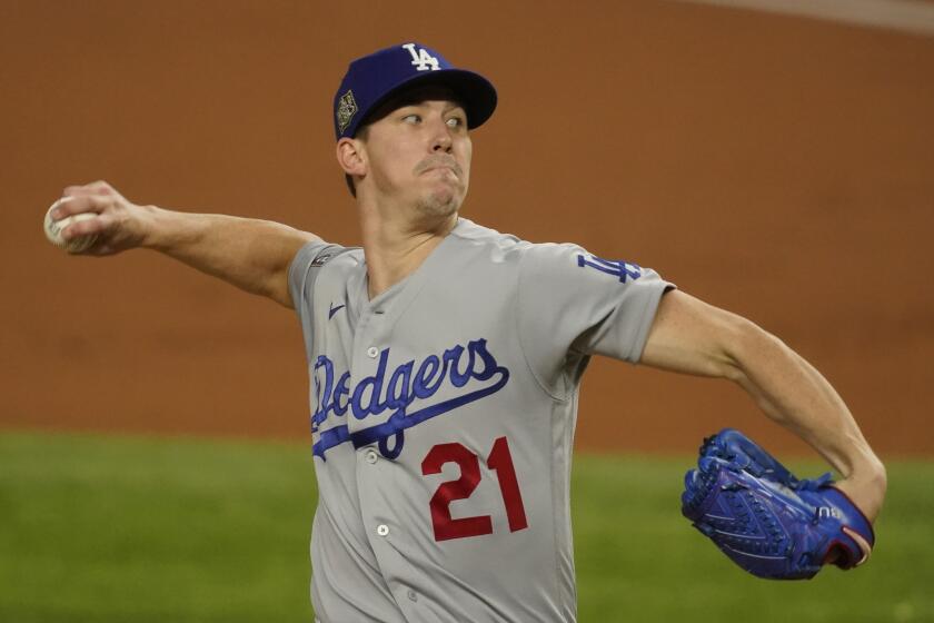 Los Angeles Dodgers starting pitcher Walker Buehler throws against the Tampa Bay Rays during the first inning in Game 3 of the baseball World Series Friday, Oct. 23, 2020, in Arlington, Texas. (AP Photo/Tony Gutierrez)