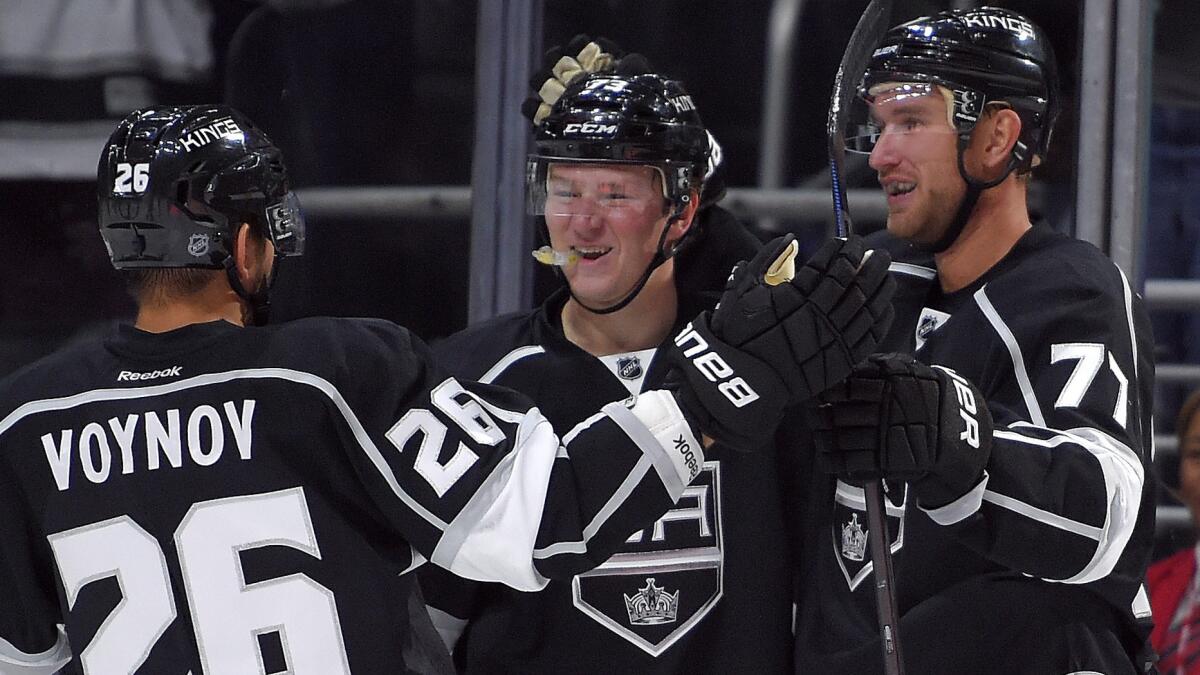 Kings center Jeff Carter, right, celebrates with teammates Tyler Toffoli, center, and Slava Voynov after scoring a goal in Saturday's win over the Winnipeg Jets.