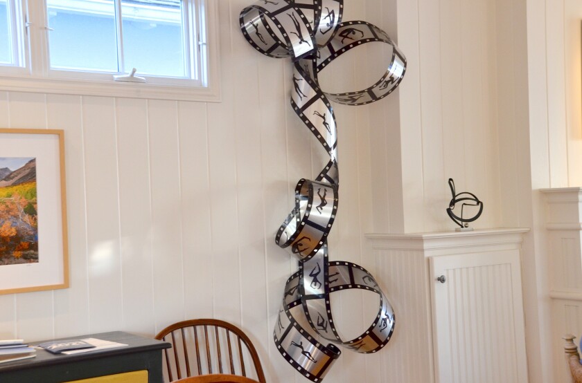 Mary Chabre's metal film strip creation hangs from the ceiling of the Peckenpaugh house in Corona del Mar.