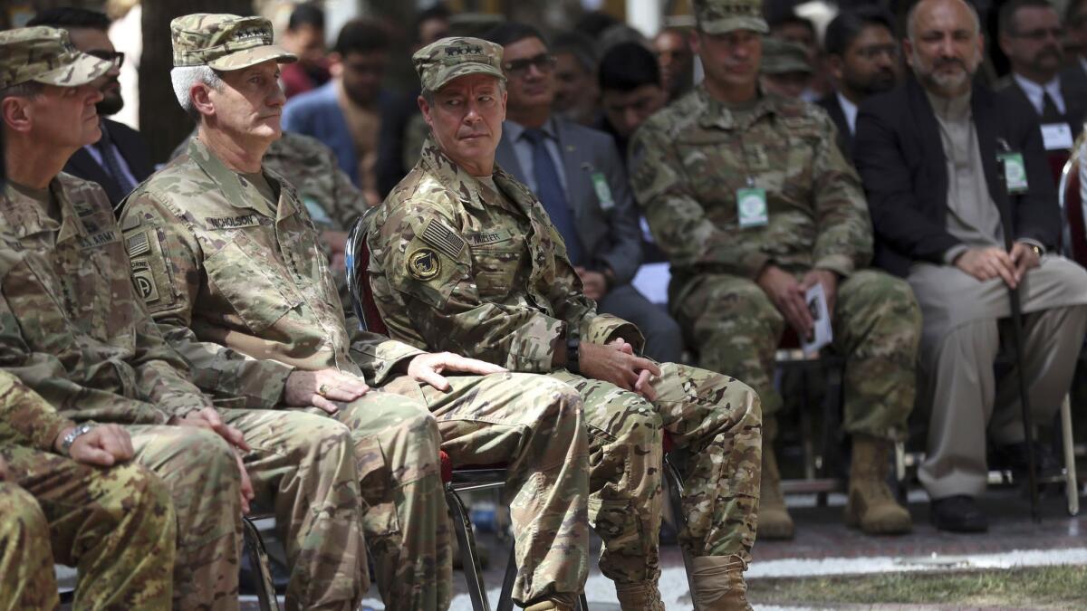 As he takes over as leader of the Resolute Support mission in Afghanistan, Gen. Austin S. Miller, third from left, looks at retiring Gen. John Nicholson, second from left, during the change of command ceremony at Resolute Support headquarters in Kabul on Sept. 2.