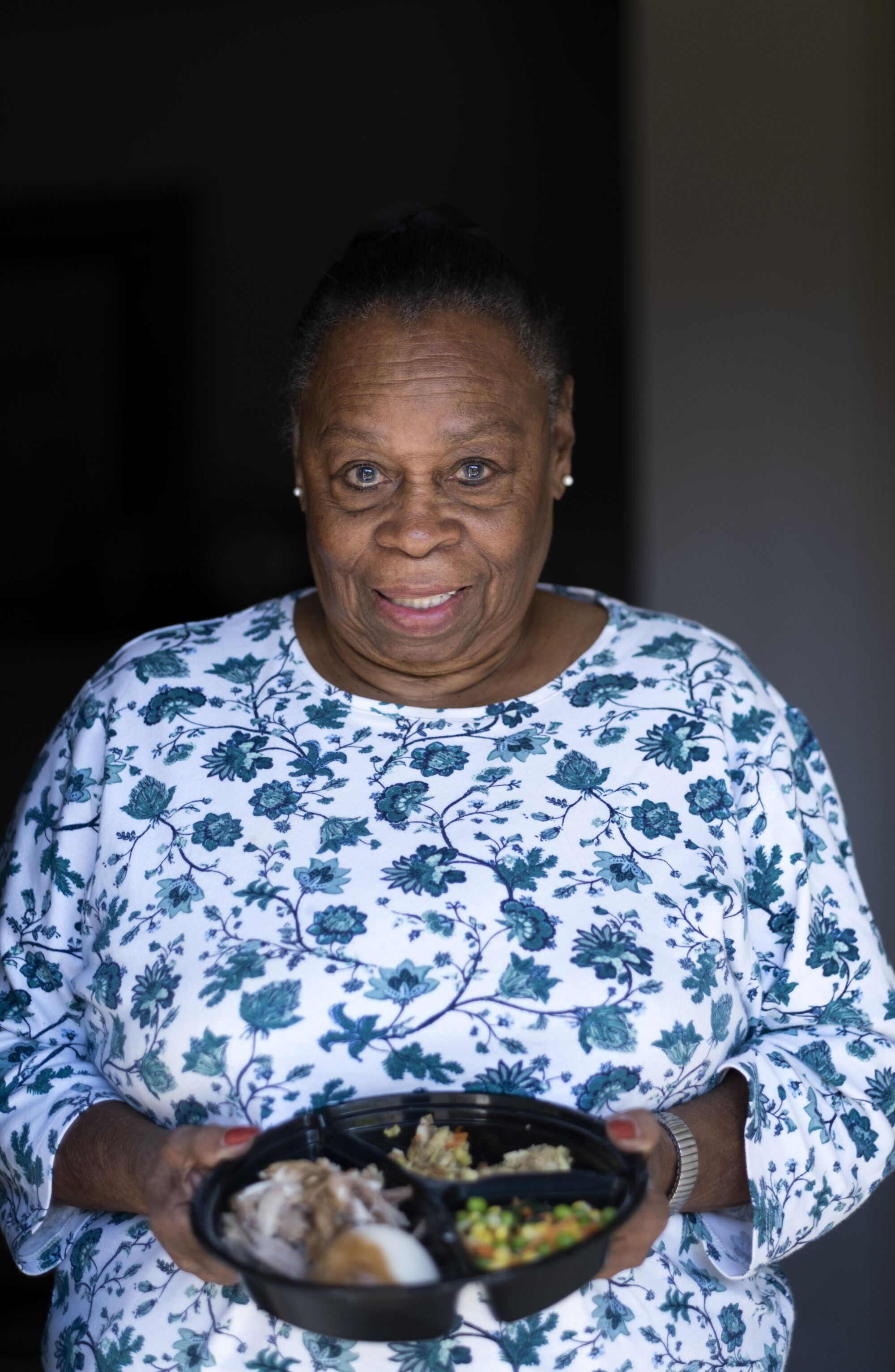 A woman hold a Thanksgiving meal.