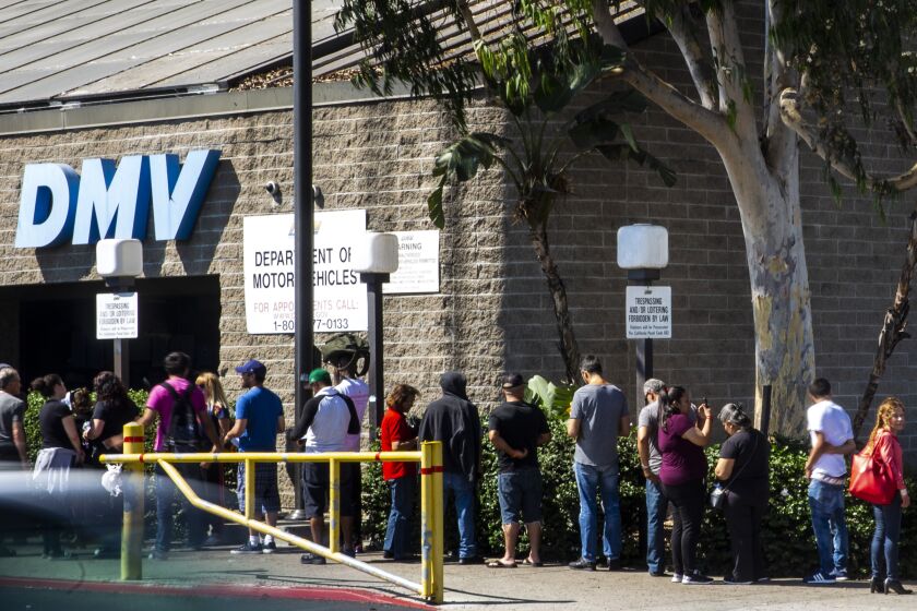 LOS ANGELES, CALIF. - AUGUST 07: A line of people wait to be helped at a California Department of Motor Vehicles Office stretches around the building at the South LA location on Tuesday, Aug. 7, 2018 in Los Angeles, Calif. (Kent Nishimura / Los Angeles Times)