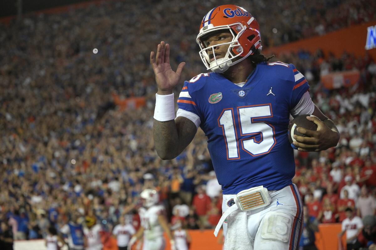 Florida quarterback Anthony Richardson (15) runs through the end zone after rushing for a 45-yard touchdown during the first half of an NCAA college football game against Utah, Saturday, Sept. 3, 2022, in Gainesville, Fla. (AP Photo/Phelan M. Ebenhack)