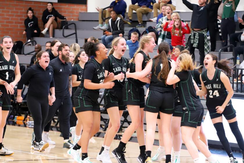 Sage Hill's girls' basketball team reacts when Ket Righeimer makes a 3 point shot at the buzzer during Sage Hill High School girls' basketball team against Mater Dei High School girls' basketball team in the semifinals of the Troy Classic basketball game at Troy High School in Fullerton on Friday, December 8, 2023. (Photo by James Carbone)