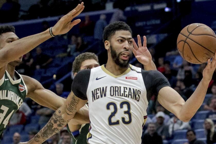 FILE - In this Tuesday, March 12, 2019 file photo, New Orleans Pelicans forward Anthony Davis (23) takes an outlet pass against Milwaukee Bucks forward Giannis Antetokounmpo (34) in the first half of an NBA basketball game in New Orleans. Pelicans basketball operations chief David Griffin says the timing of next weeks NBA draft wont necessarily raise urgency to trade disgruntled six-time All-Star Anthony Davis. The Pelicans have the first overall pick in the June 20 NBA draft and likely could acquire more high picks by dealing Davis by then.(AP Photo/Scott Threlkeld, File)