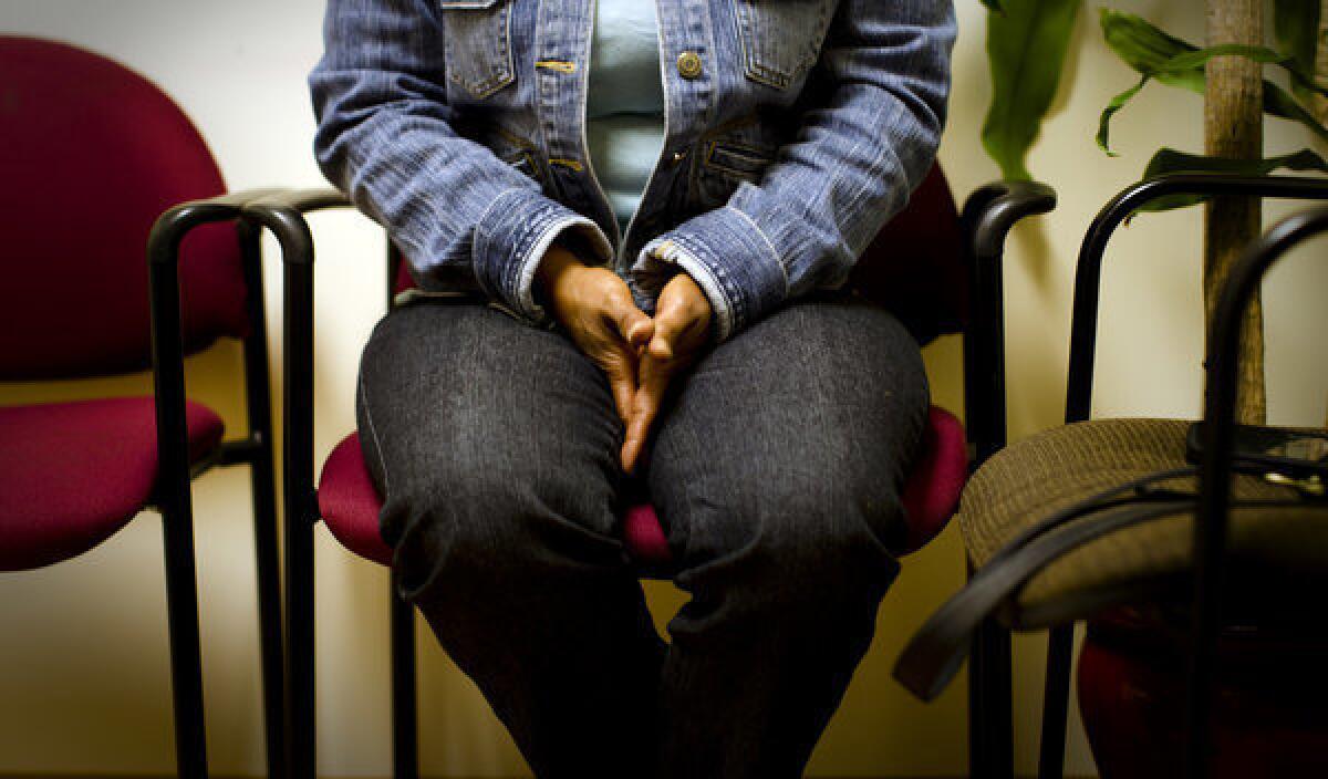 Kimberly Eckford, 49, nervously rubs her hands together while speaking about her depression for the first time with a therapist at T.H.E. Clinic.