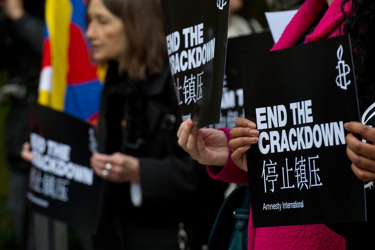 In London, demonstrators hold signs with the slogan "End the crackdown" in protest of human rights violations and censorship of the Internet and media in China. Chinese President Xi Jinping visited England in October.
