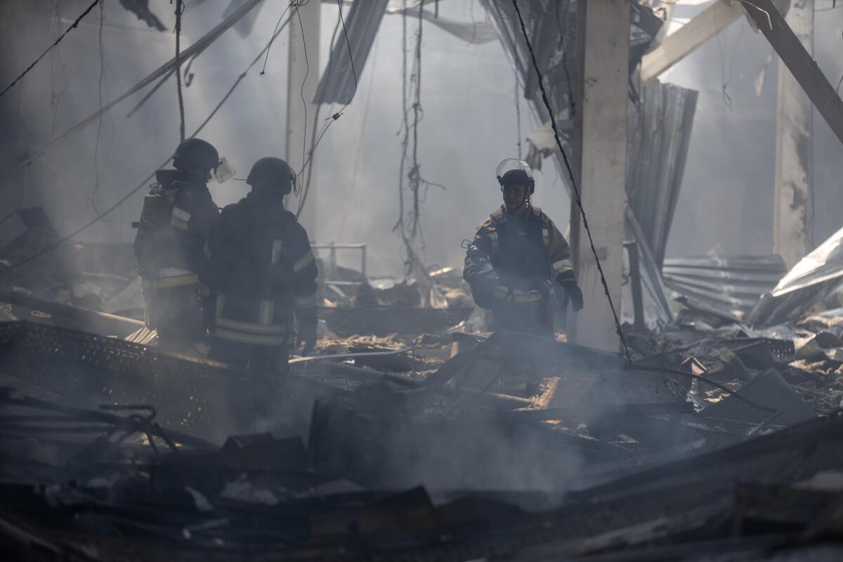 Emergency workers search for victims after Russian missile hit a supermarket in Ukraine.