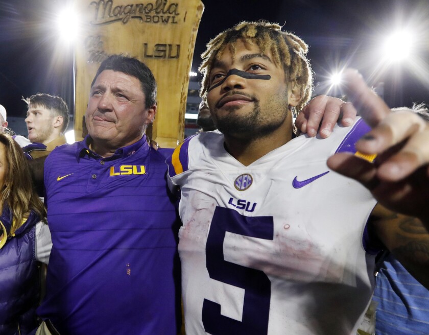 LSU coach Ed Orgeron, left, celebrates with running back Derrius Guice following a win over Mississippi in 2017.