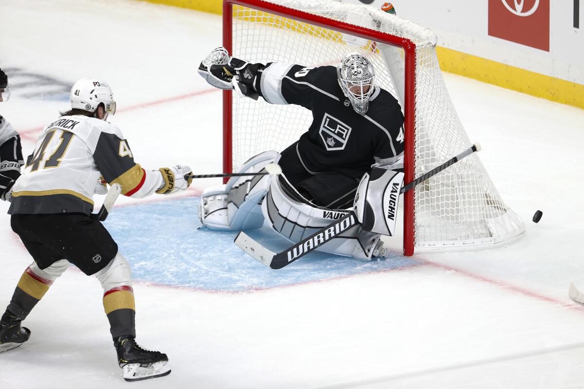 Kings goalie Cal Petersen reacts as Vegas Golden Knights forward Nolan Patrick take a shot.