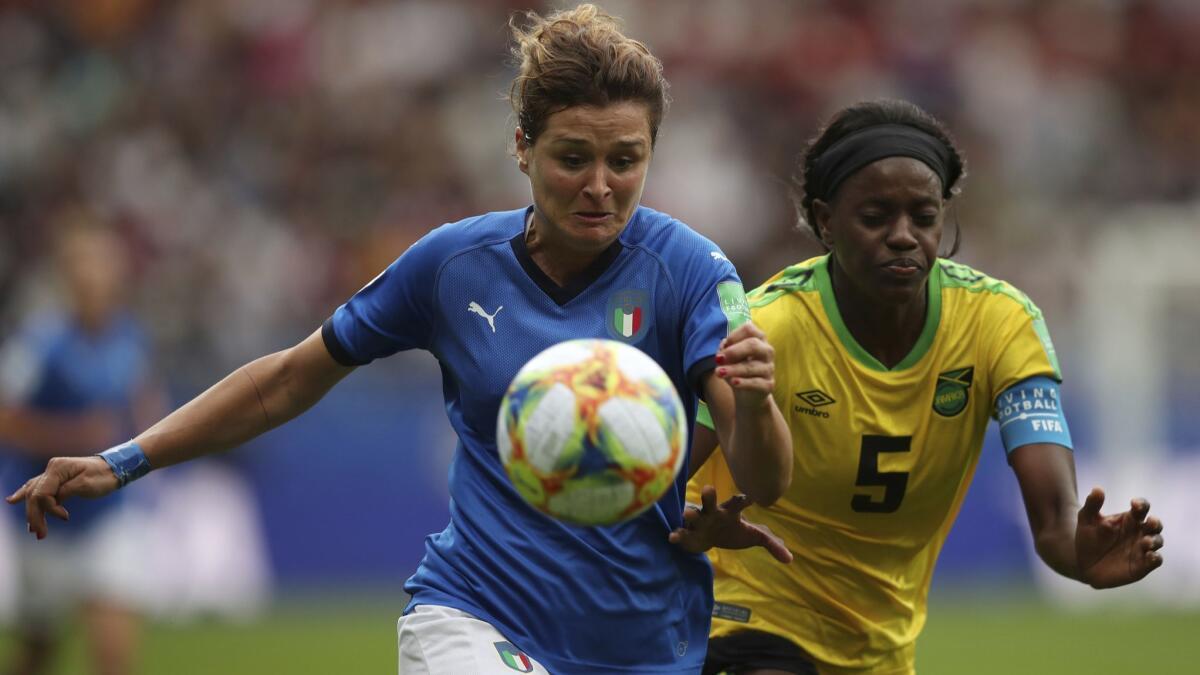 Italy's Cristiana Girelli, left, fights for the ball with Jamaica's Konya Plummer during a Women's World Cup match Friday in Reims, France, Friday, June 14, 2019. (AP Photo/Francisco Seco)