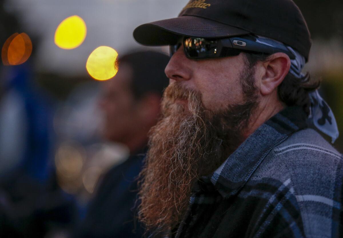 A part-time worker waits near the gate at the dispatch hall. (Mark Boster / Los Angeles Times)