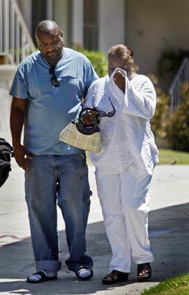 Frank Feagin, left, and his mother, Florita Feagin, react to seeing the scene where Frank's childhood friend, Kevin Wicks, 38, was fatally shot by a police officer. Police say they were responding to a disturbance call at the Inglewood apartment complex in the 100 block of North Hillcrest Boulevard about 12:30 a.m., and an armed man opened the door and allegedly pointed the weapon at the officers. One of the officers shot Wicks, who was taken to a hospital where he died.