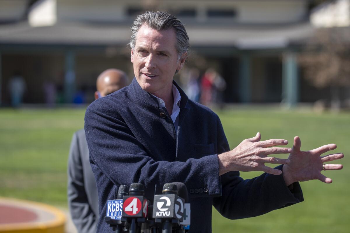 FILE - In this March 2, 2021 file photo California Gov. Gavin Newsom speaks about the state's plan to reopen schools as coronavirus vaccinations continue during a news conference on the schoolyard at Barron Park Elementary in Palo Alto, Calif. The annual State of the State address Newsom will deliver on Tuesday, March 9, 2021, will be one of the most important speeches of his political career. It comes about a year after his first coronavirus stay-at-home order and as he faces a potential recall election. (Karl Mondon/Bay Area News Group via AP, File)